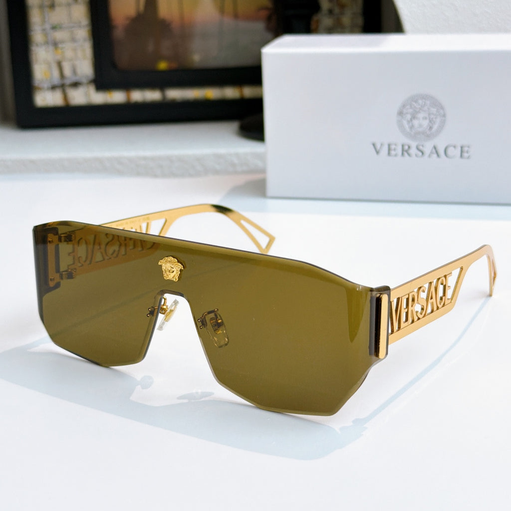 Gold-framed sunglasses with dark amber mirrored lenses and Versace logo arms