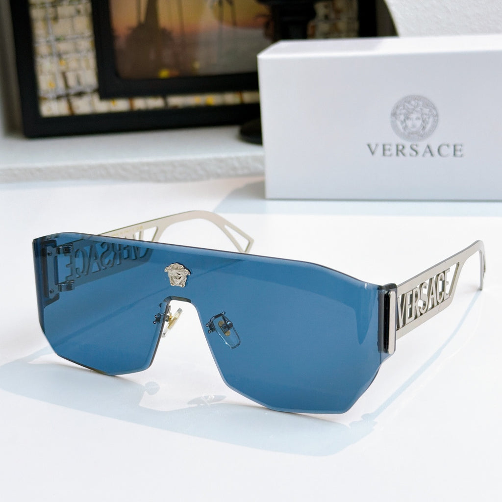 Gold-framed sunglasses with bright blue mirrored lenses and Versace logo arms