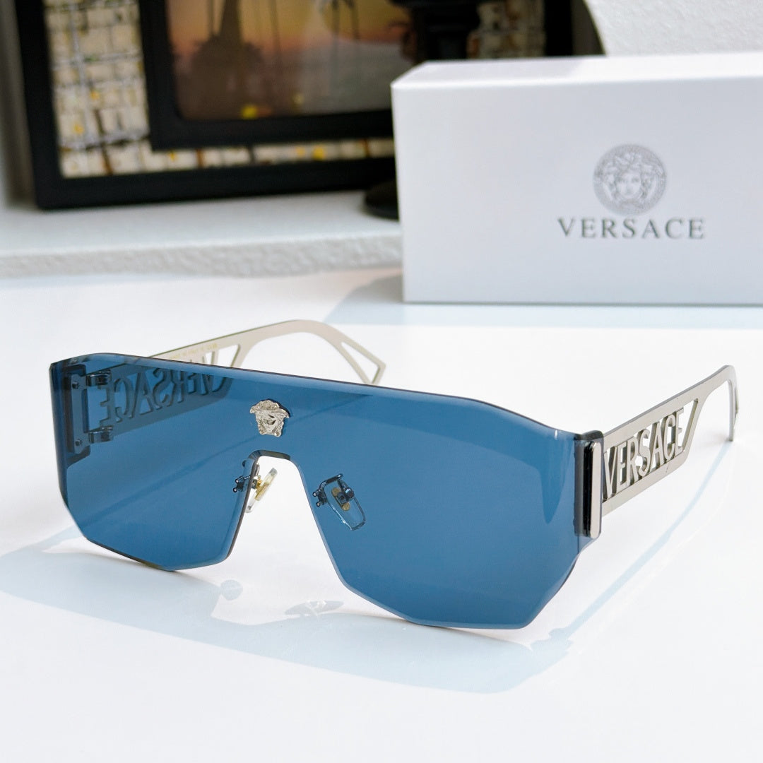 Gold-framed sunglasses with bright blue mirrored lenses and Versace logo arms