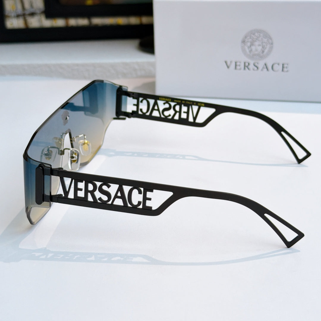 Black sunglasses with clear lenses, gold hardware, and Versace logo arms