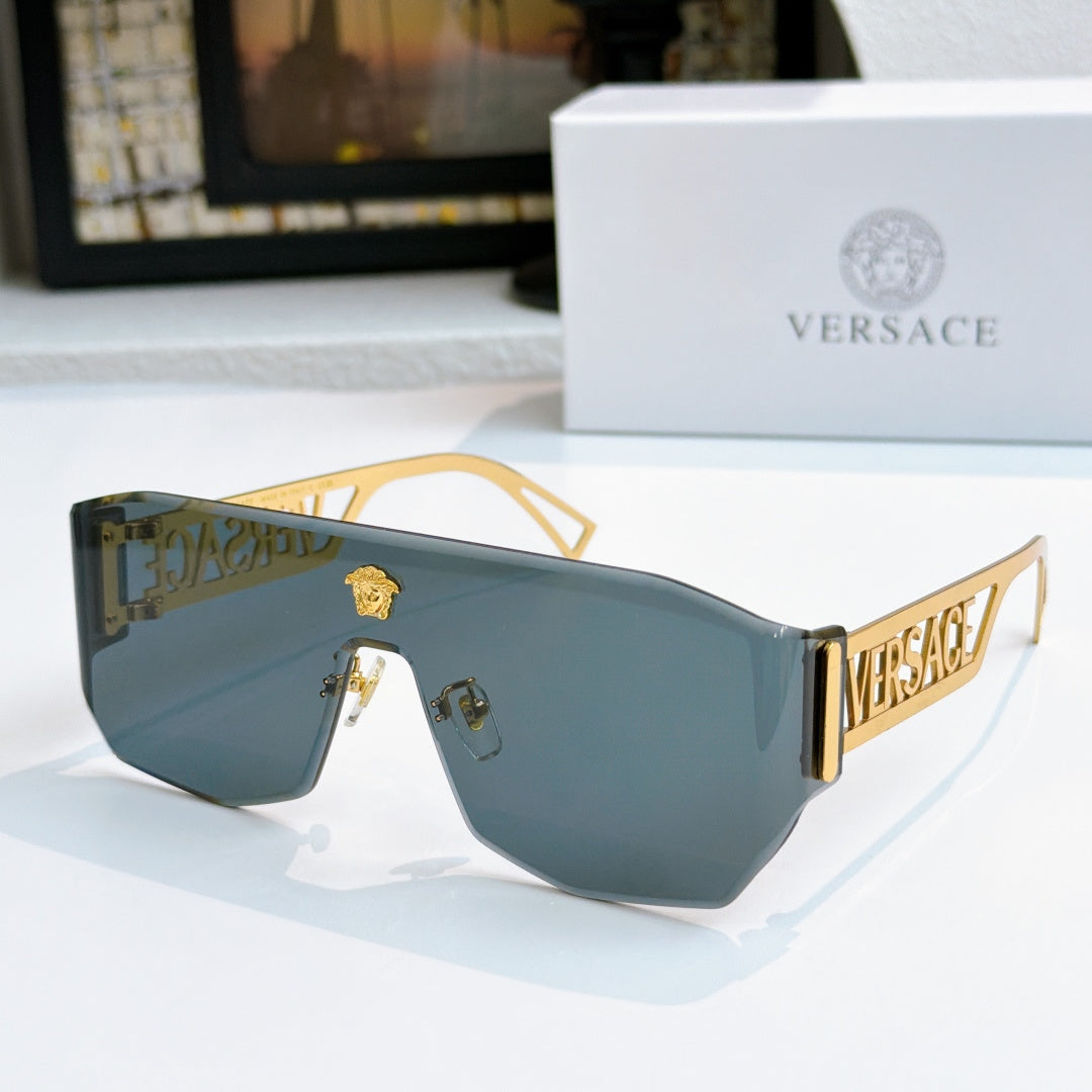 Gold-framed sunglasses with blue mirrored lenses and Versace logo arms