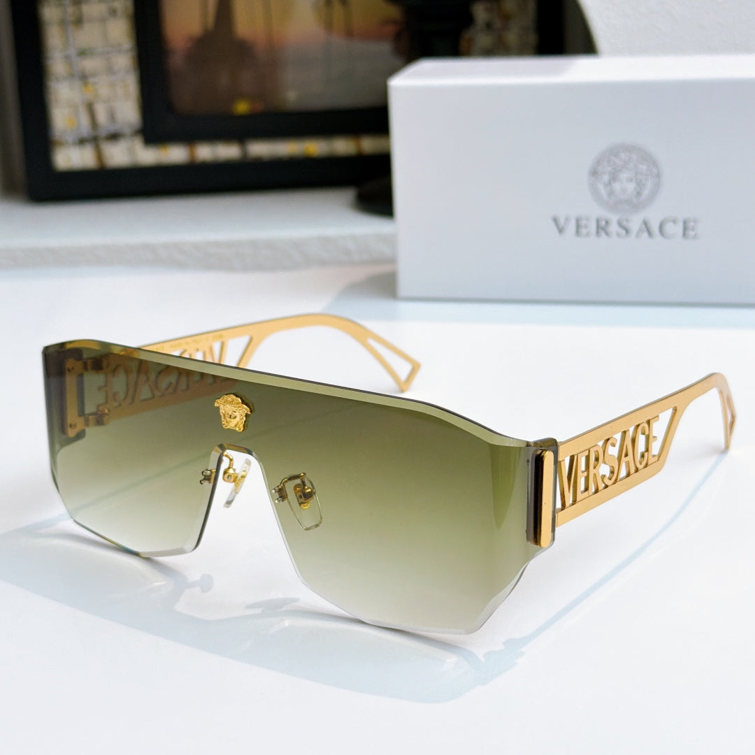 Gold-framed sunglasses with pale green mirrored lenses and Versace logo arms