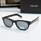 Prada sunglasses with black frames and gray lenses, logo on side temple