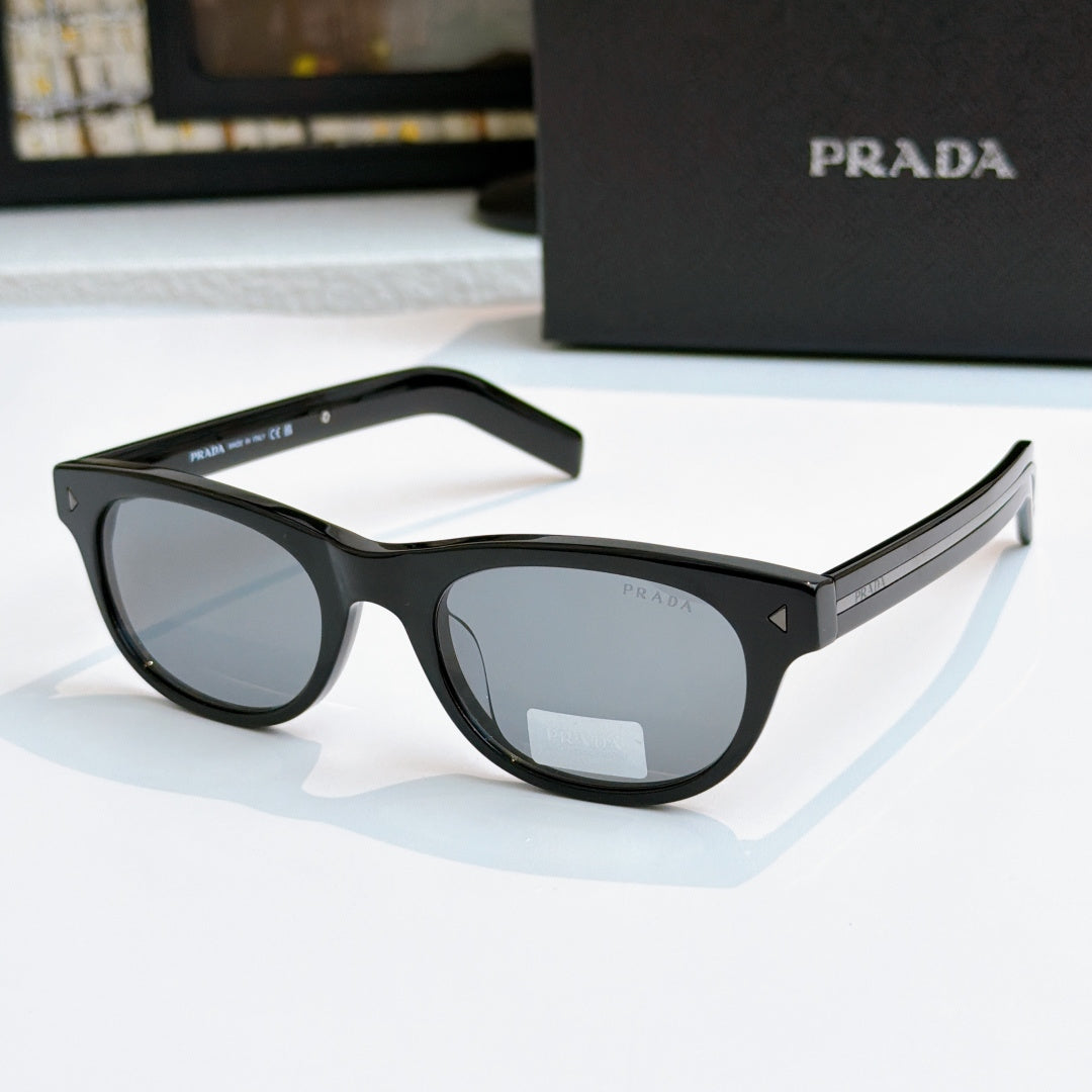 Prada sunglasses with black frames and gray lenses, logo on side temple