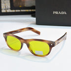Prada sunglasses with tortoise frames and bright green lenses, logo on side temple