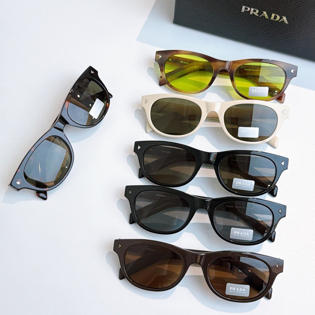 Prada sunglasses collection with various frames and tinted lenses on display