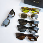 Prada sunglasses collection with various frames and tinted lenses on display