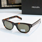 Prada sunglasses with black frames, dark lenses, and logo detail on temple