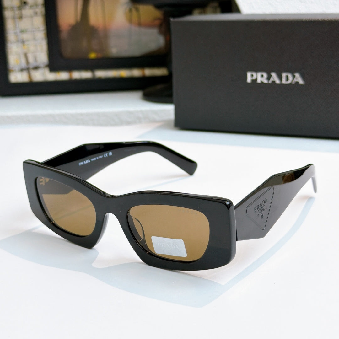 Prada black glasses with brown tinted lenses and glossy temples