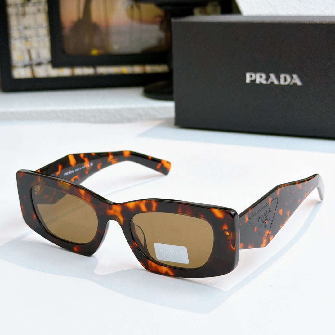 Prada orange tortoise glasses with amber tinted lenses and angled arms