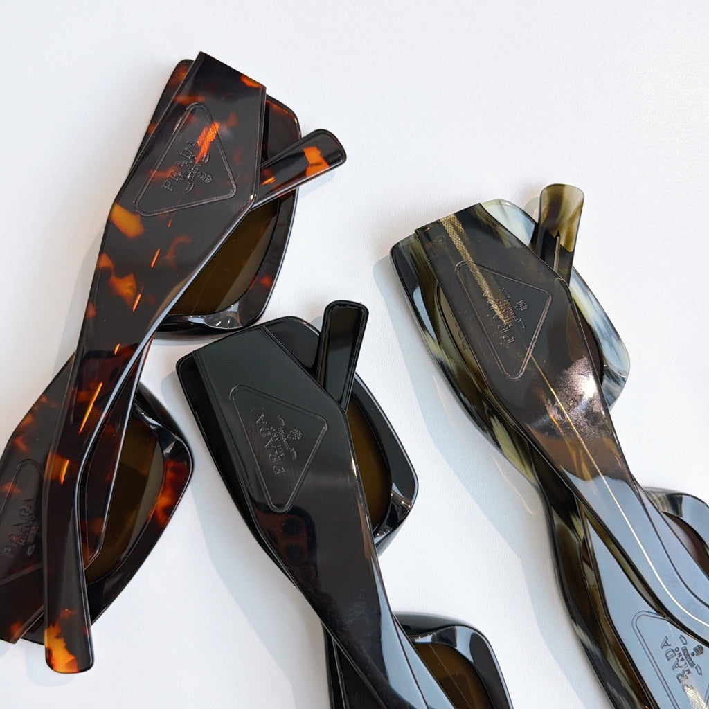 Prada glasses frames and temples in tortoise and dark tones, close-up