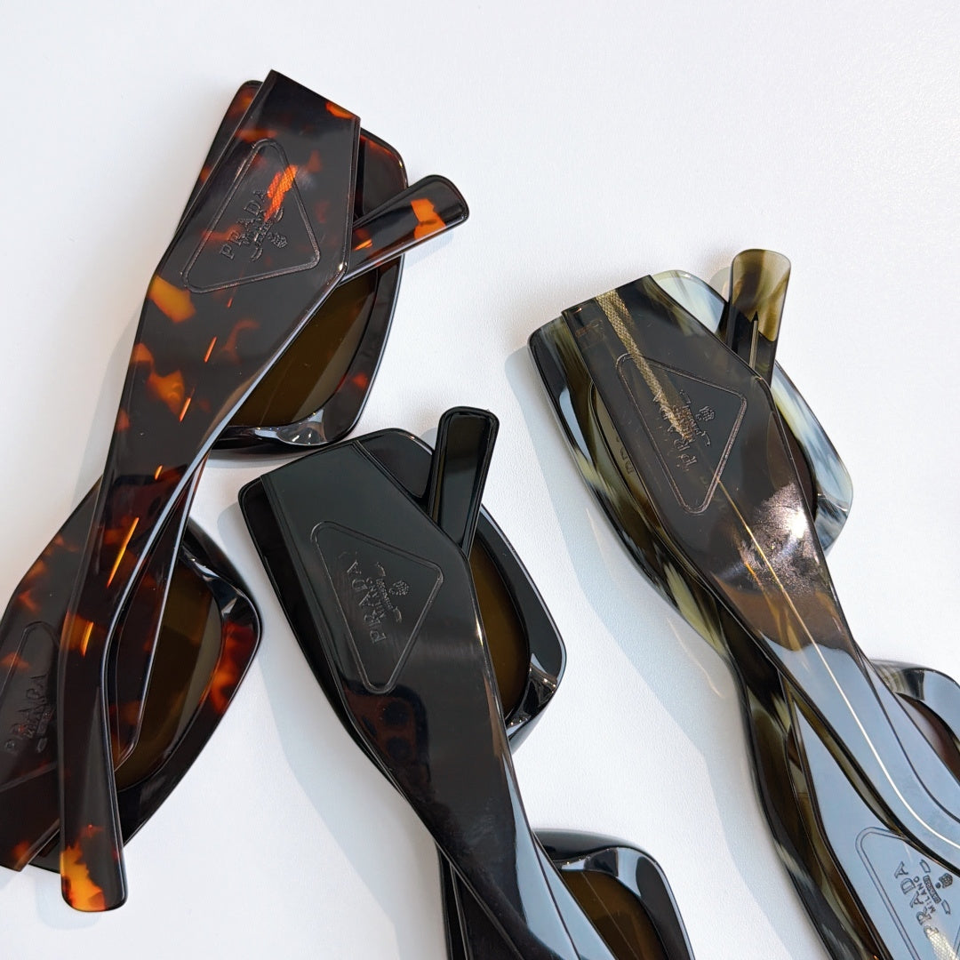 Prada glasses frames and temples in tortoise and dark tones, close-up
