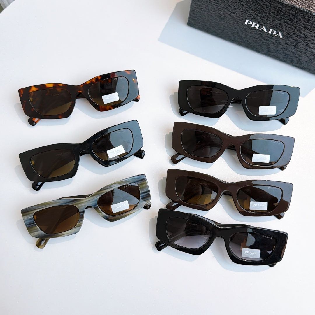 Prada glasses assortment with multiple frame colors and dark lenses, laid out
