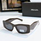 Prada dark brown glasses with dark lenses, cat-eye shape, logo temples