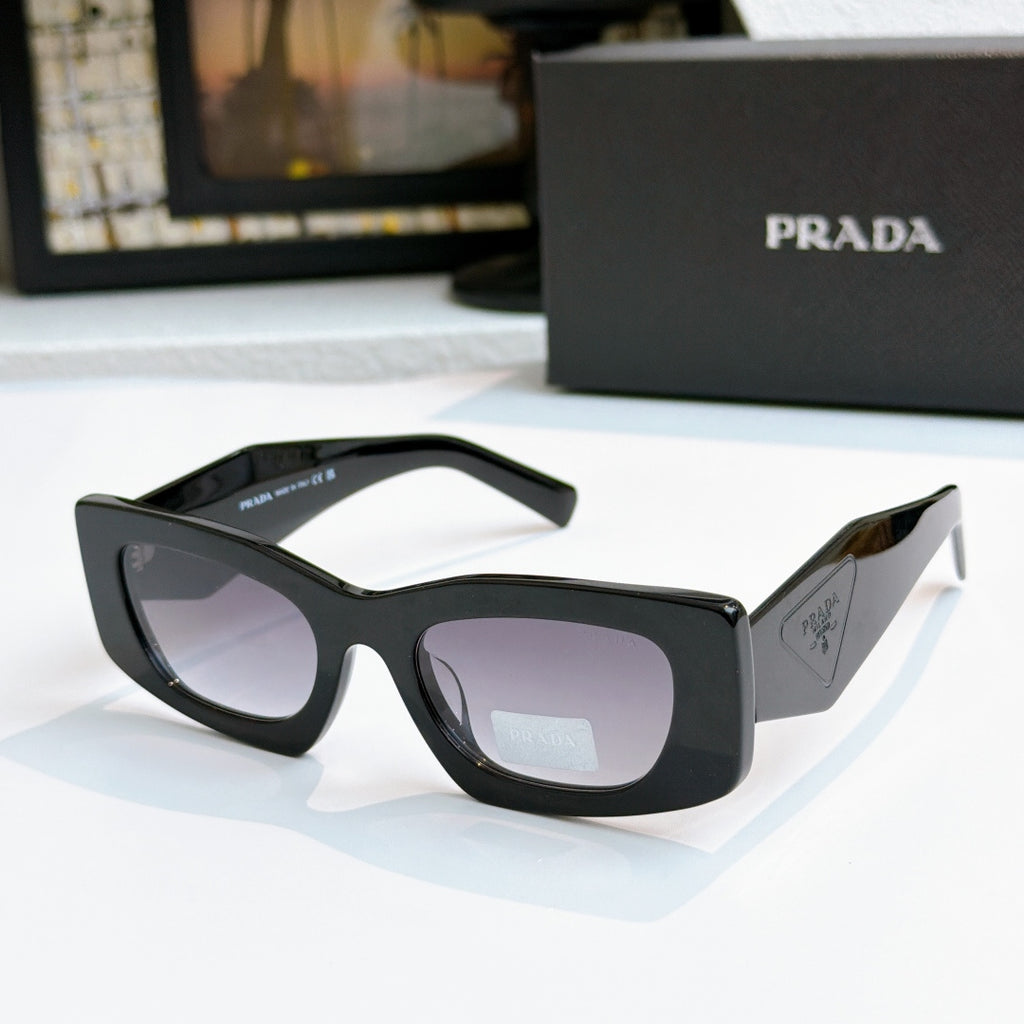 Prada black glasses with dark lenses and glossy frame, cat-eye style