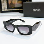 Prada black glasses with dark lenses and glossy frame, cat-eye style
