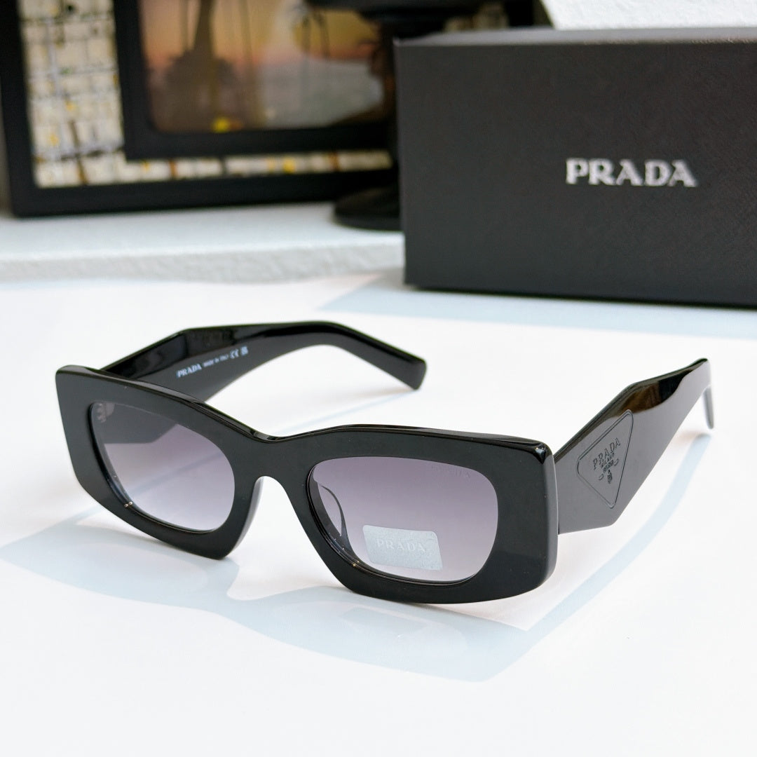 Prada black glasses with dark lenses and glossy frame, cat-eye style