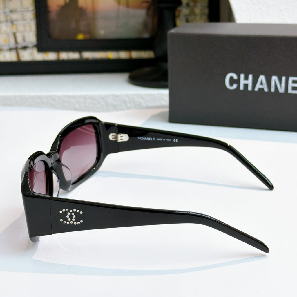 Black oversized glasses with pink tinted lenses, side view