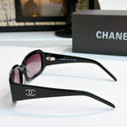 Black oversized glasses with pink tinted lenses, side view