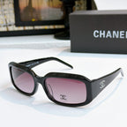 Black cat-eye glasses with mauve-pink tinted lenses and side logo detail