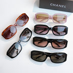 Assorted sunglasses with orange, pink, and black frames with tinted lenses
