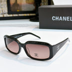 Black cat-eye glasses with rose-pink tinted lenses and side logo detail