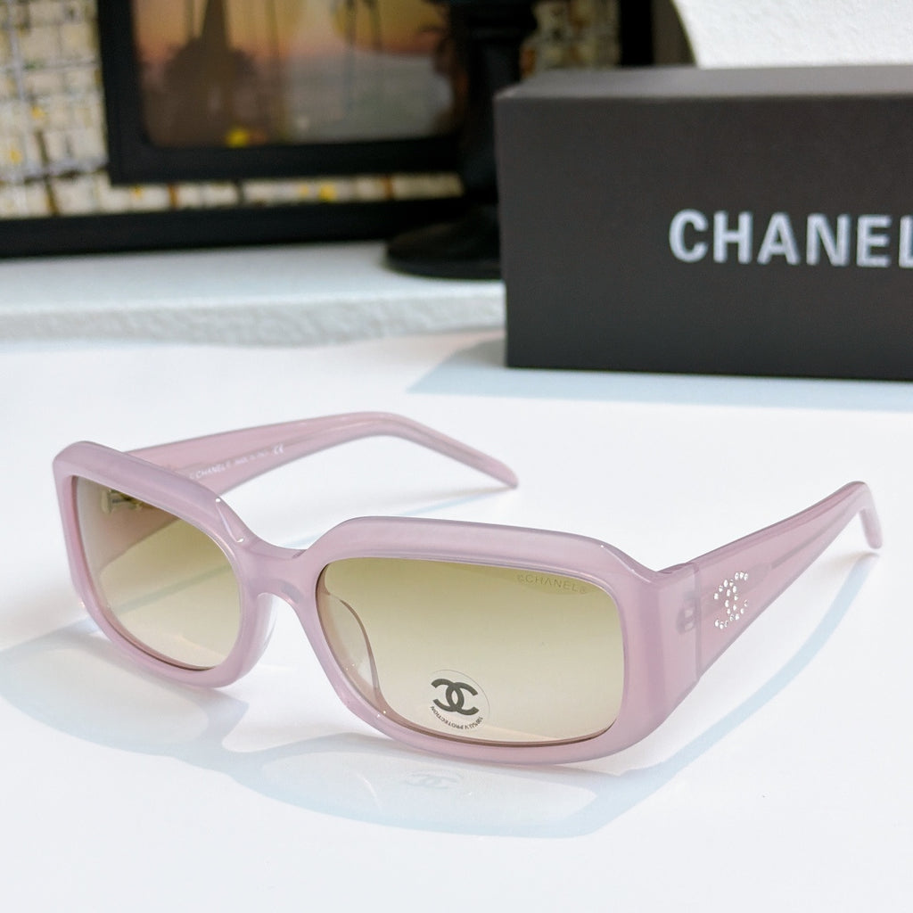 Light pink cat-eye glasses with pale yellow tinted lenses and side logo detail