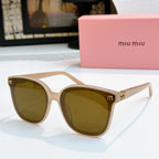 MiuMiu beige cat-eye sunglasses with olive-brown lenses and gold-tone accents
