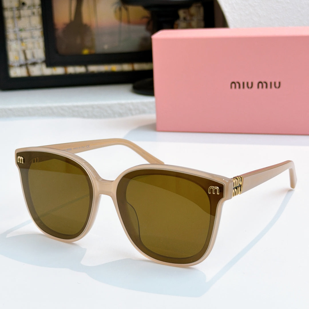 MiuMiu beige cat-eye sunglasses with olive-brown lenses and gold-tone accents