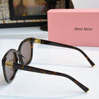 MiuMiu tortoise cat-eye sunglasses, side profile with gold-tone details