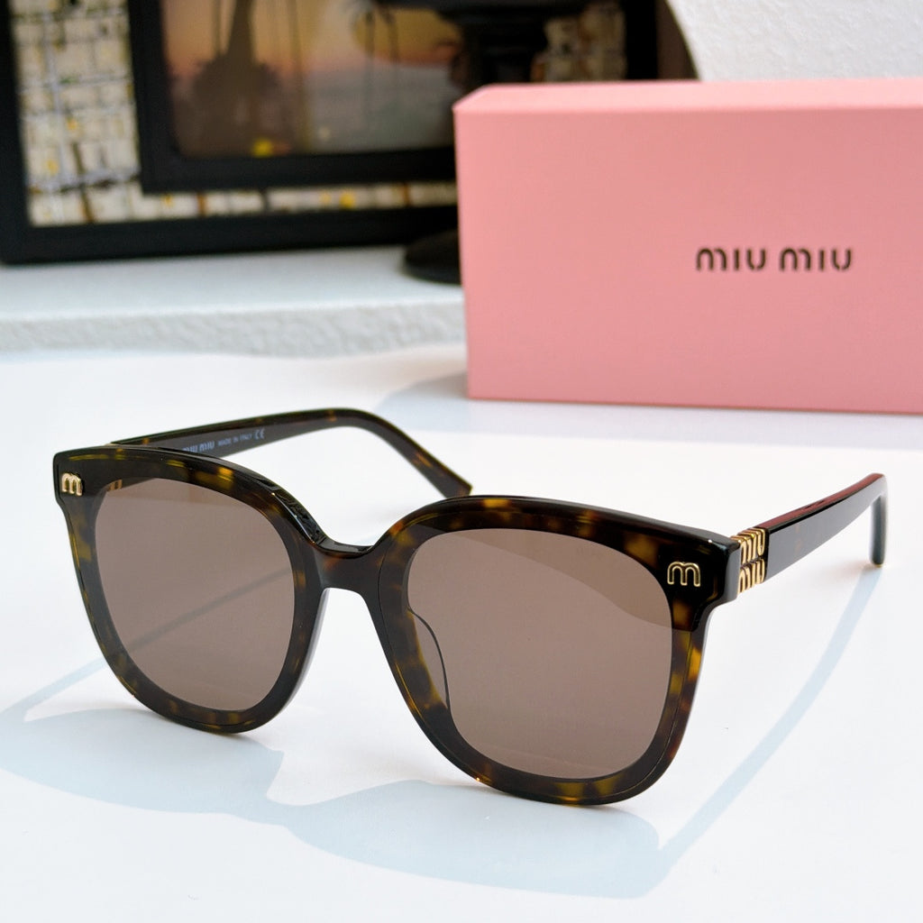 MiuMiu tortoise cat-eye sunglasses with smoky lenses and gold-tone logo