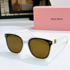 MiuMiu white cat-eye sunglasses with amber-brown lenses and gold-tone accents