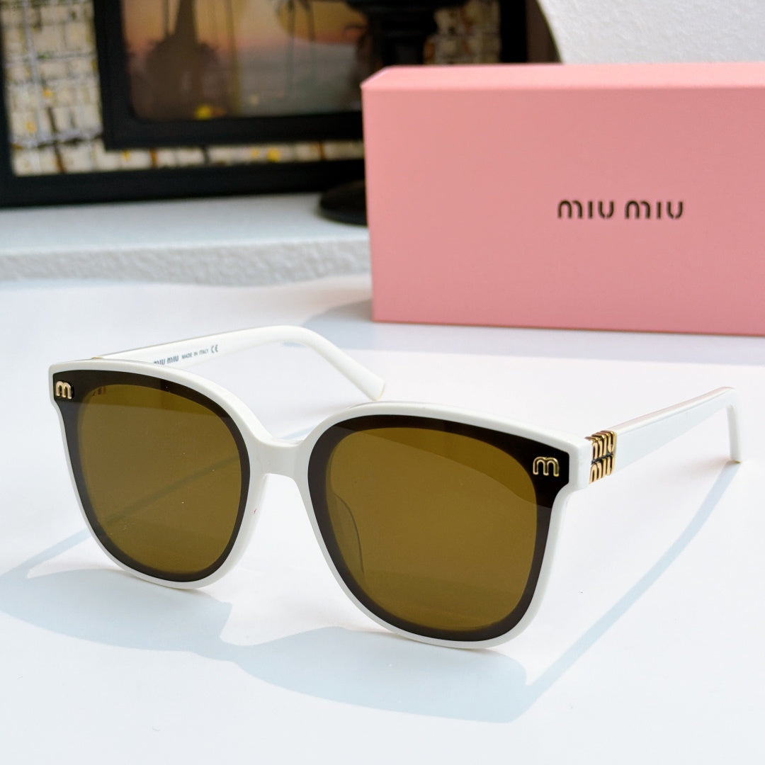 MiuMiu white cat-eye sunglasses with amber-brown lenses and gold-tone accents