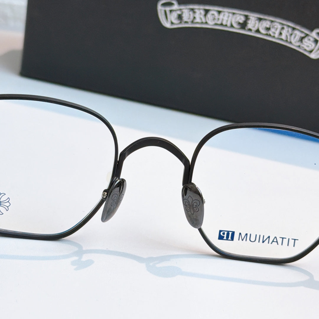 Round black eyeglasses with blue-tinted lens panels and small side emblem