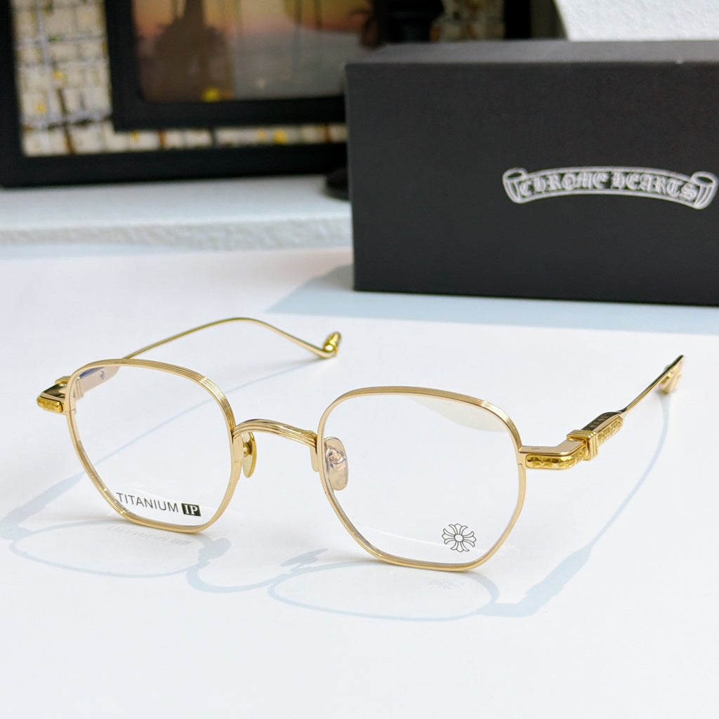 Round eyeglasses with gold frame, blue-tinted lenses, and engraved temple arms