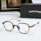 Round eyeglasses with dark frame, blue-tinted lenses, and patterned metal temples