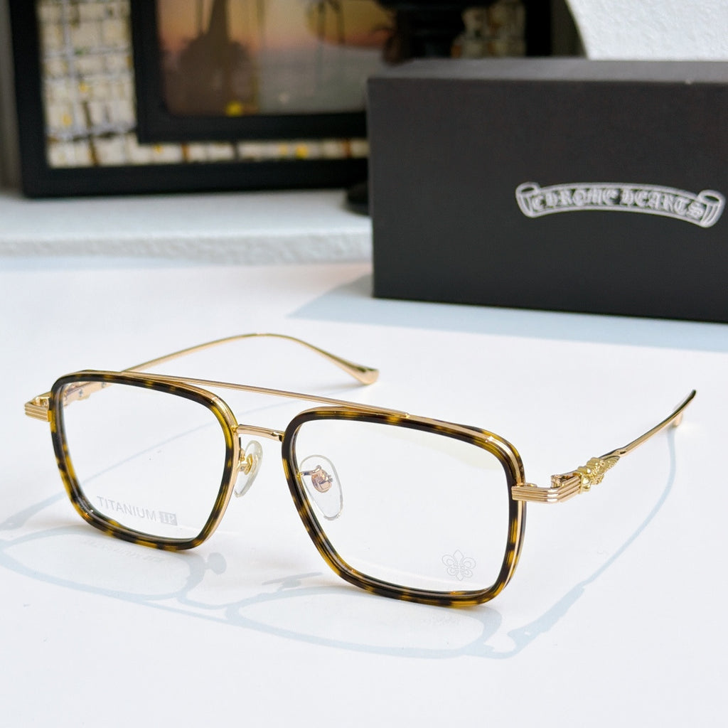 Gold and dark eyeglass frames with clear lenses and thin temples