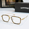 Gold and dark eyeglass frames with clear lenses and thin temples