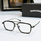 Black eyeglass frames with clear lenses and decorative metal temple arms