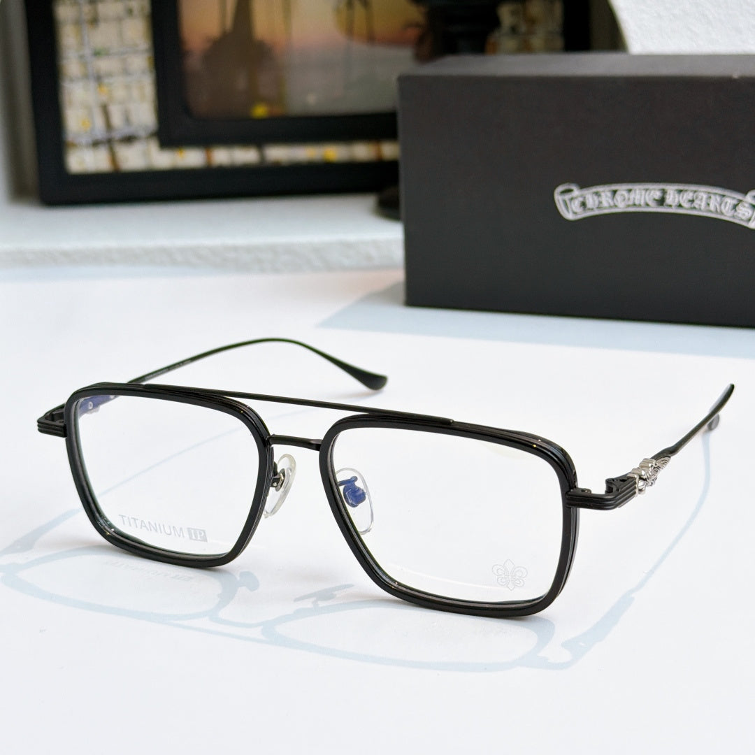 Black eyeglass frames with clear lenses and decorative metal temple arms