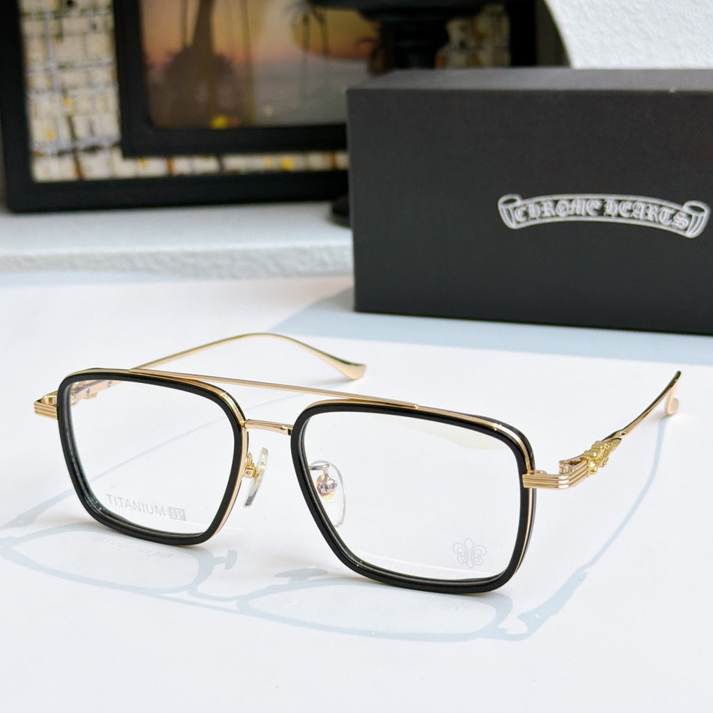 Gold and dark eyeglass frames with clear lenses and gold temple accents