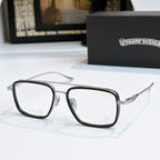 Silver eyeglass frames with clear lenses and ornate metal temple detail