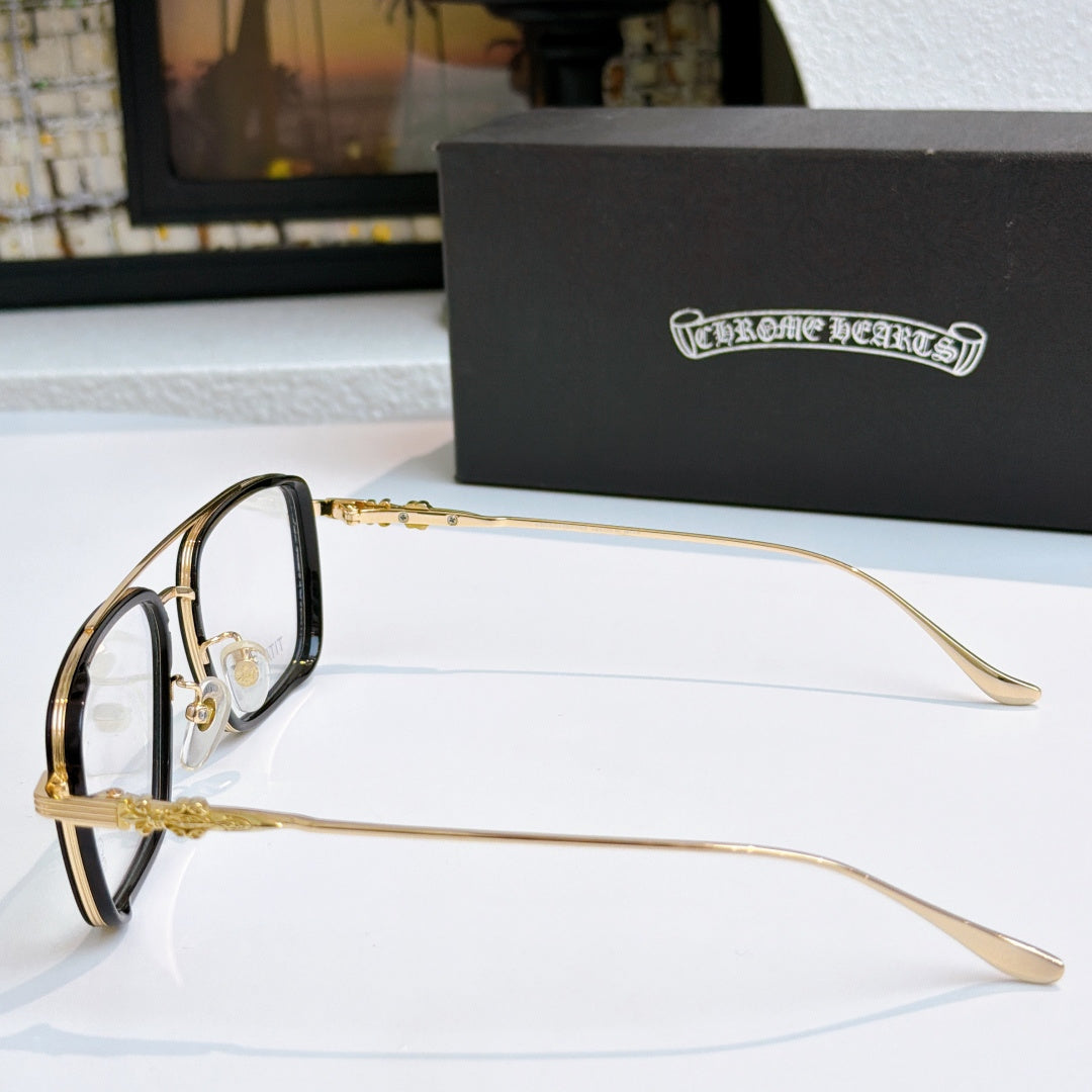 Gold eyeglass frames with clear lenses and ornate temple detail