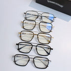 Set of eyeglasses with clear lenses in black, silver, and gold frames