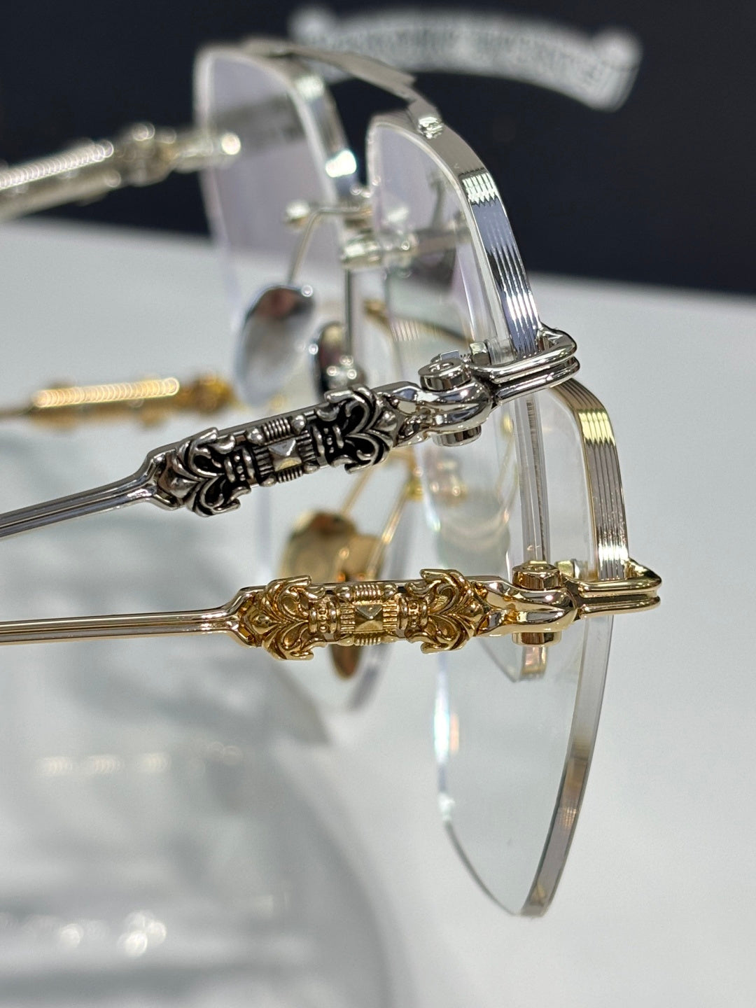 Chrome eyeglasses closeup with clear lenses and metal hinge ornaments