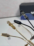 Chrome eyeglasses closeup with black and gold frames and clear lenses
