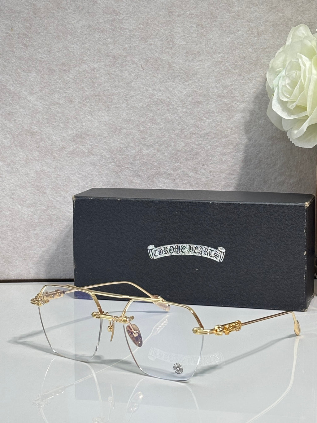 Chrome eyeglasses with gold frame front, clear lenses and decorative temples
