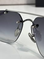 Chrome glasses with dark lenses and silver metal frame, close side profile