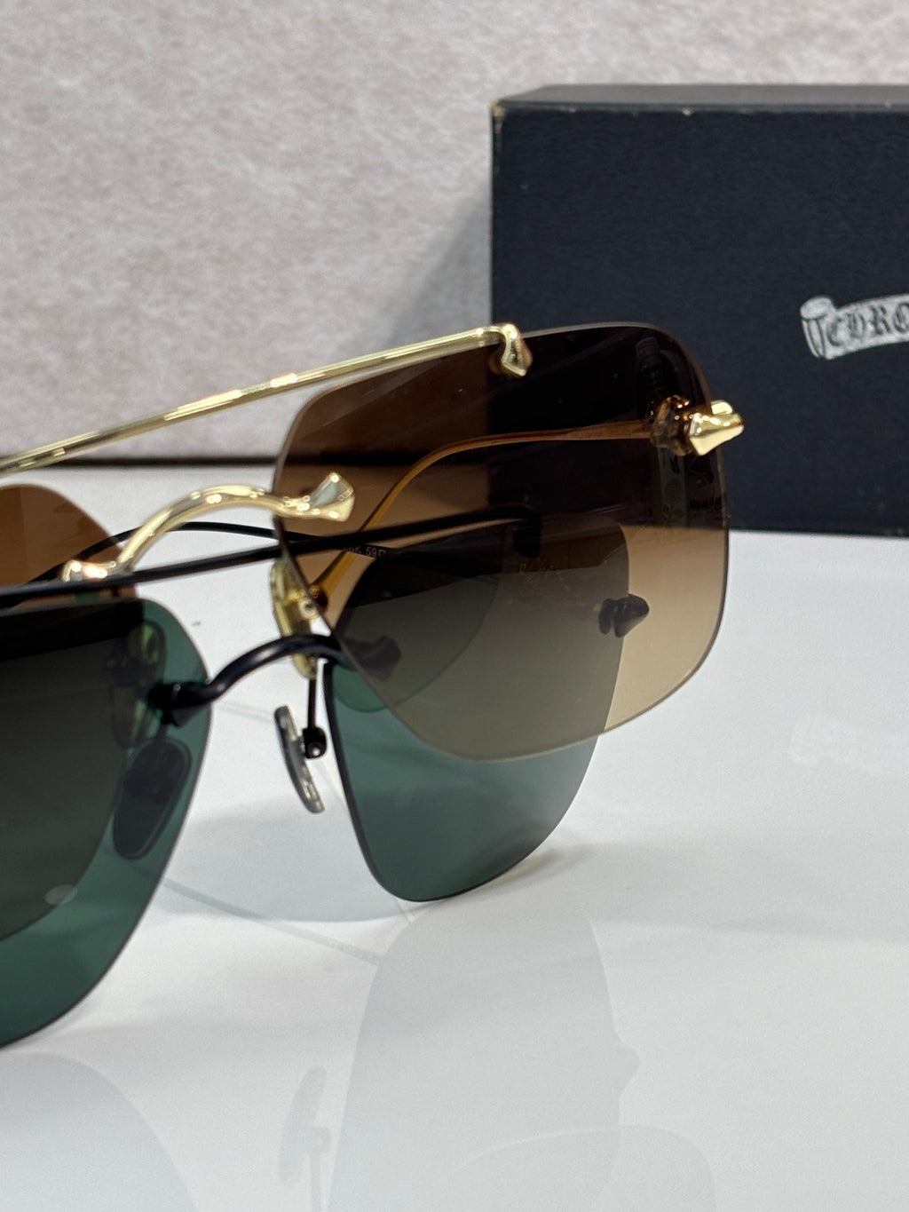 Chrome glasses with amber-tinted lenses and gold metal frame, close-up