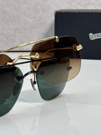 Chrome glasses with amber-tinted lenses and gold metal frame, close-up
